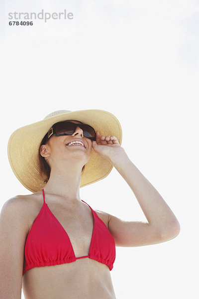 Young woman in bikini  protective hat and sunglasses