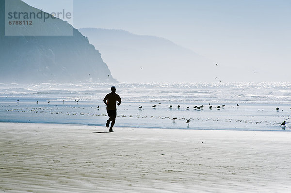 Mann Strand Silhouette joggen