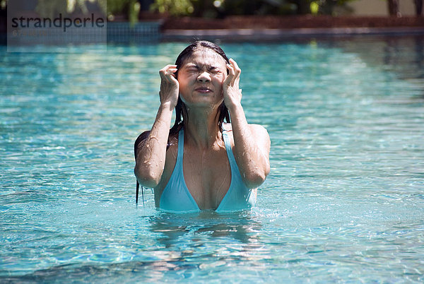 Thailand  Bangkok  Thai woman in swimming pool.