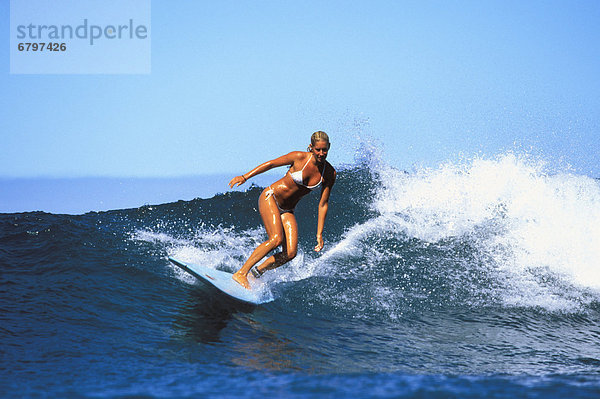 Surfer girl  Jessica Bishop riding a wave