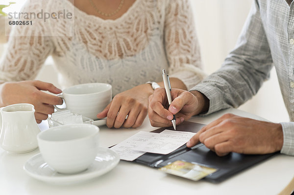 Couple enjoying tea  man signing receipt