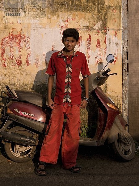stehend  Portrait  Junge - Person  Gasse  frontal  Kickboard  Indien  Kerala