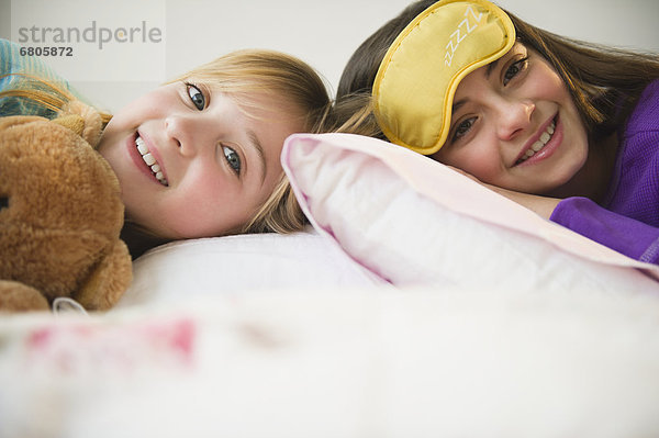 Zwei Mädchen im Bett liegend