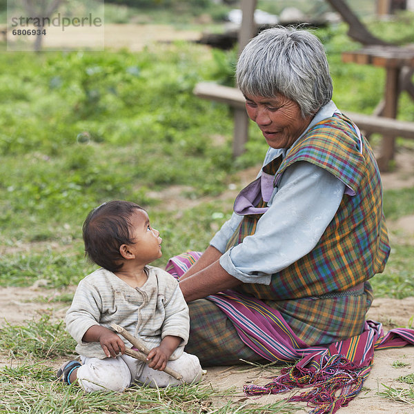 Senior Bhutanese Woman With Baby  Punakha District Bhutan