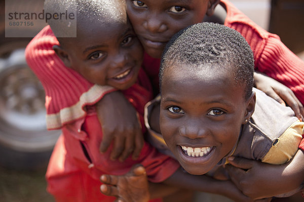 Three Children In An Embrace  Kampala Uganda Africa