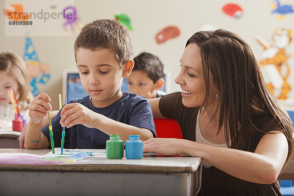 Teacher with children (4-5  6-7) during art classes