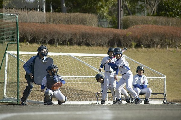 Boys playing baseball  player at home plate