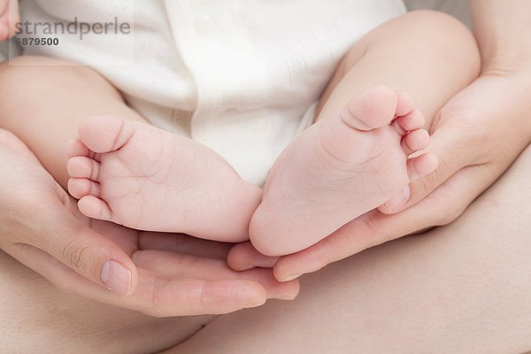 Baby's Feet on Mother's Hands