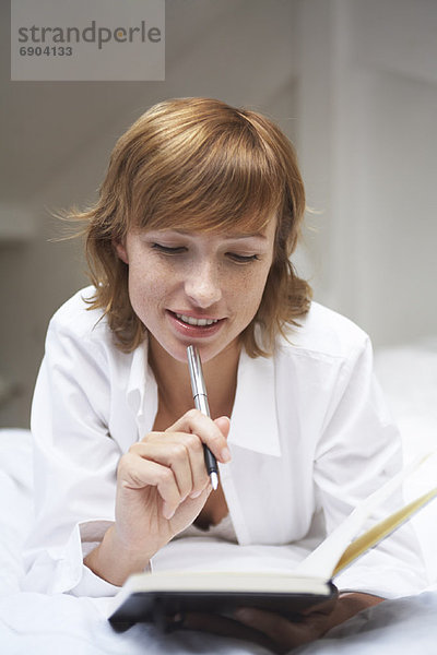 Frau Writing in Journal