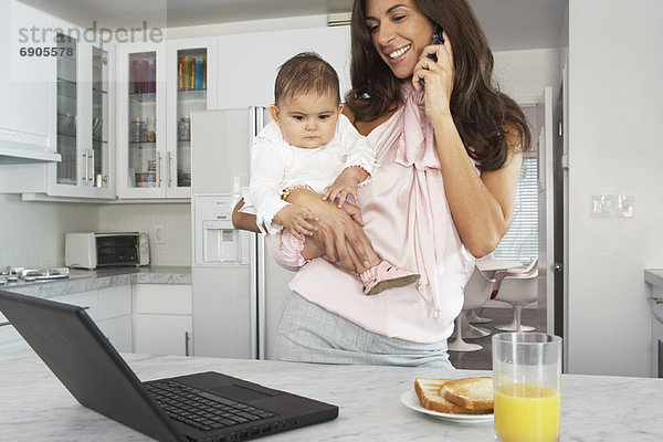 Mother with Baby  Talking on Cell Phone