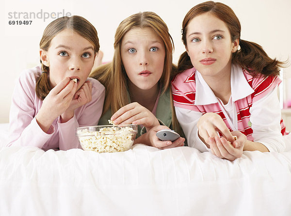Girls Lying on Bed  Eating Popcorn