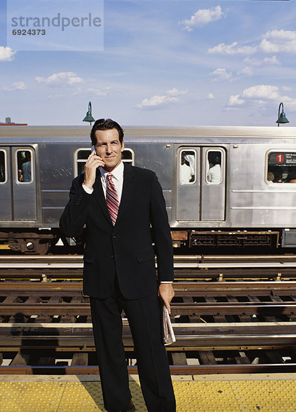 Businessman on Subway Platform  Talking on Cellular Phone