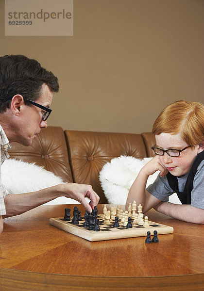 Vater und Sohn spielen von Schach