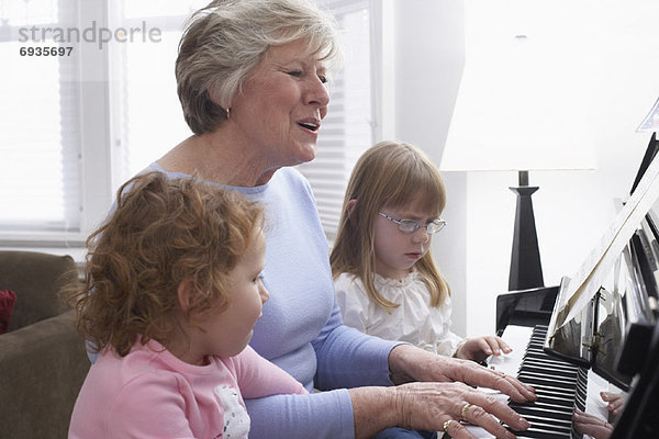 Frau  Enkeltochter  Klavier  spielen