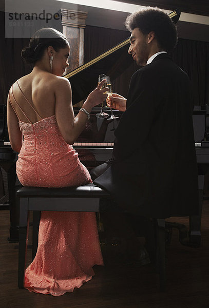 Couple Sitting at Piano  Making a Toast