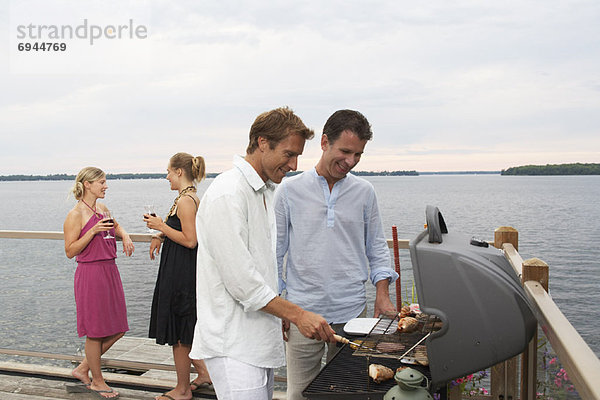 People Barbecuing  Standing by Lake
