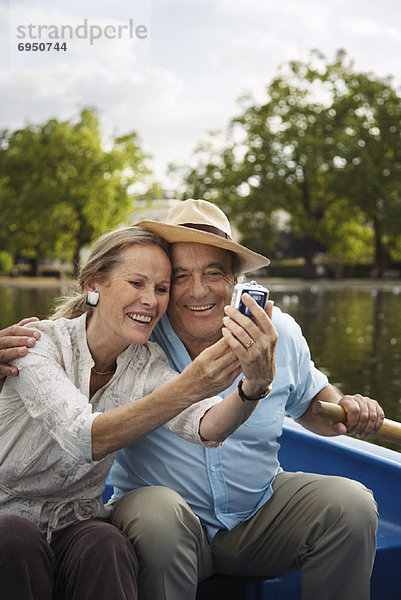 Couple in Rowboat  Taking Photo of Themselves