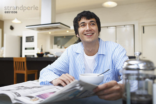Man Eating Breakfast  Reading Newspaper