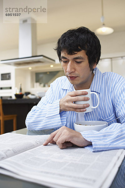Man Drinking Coffee  Reading Newspaper