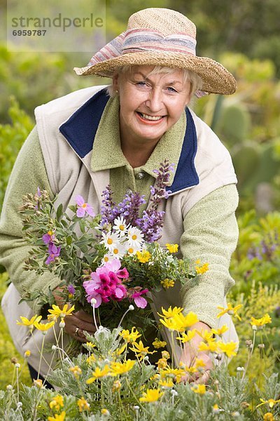 Portrait of Woman in Meadow  Collecting Flowers