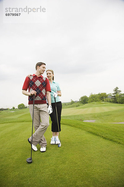 Paar stehend auf Golfplatz