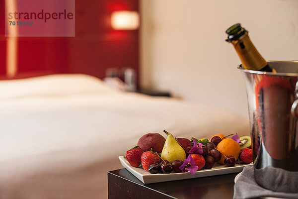 Obstteller und Champagner im Hotelzimmer