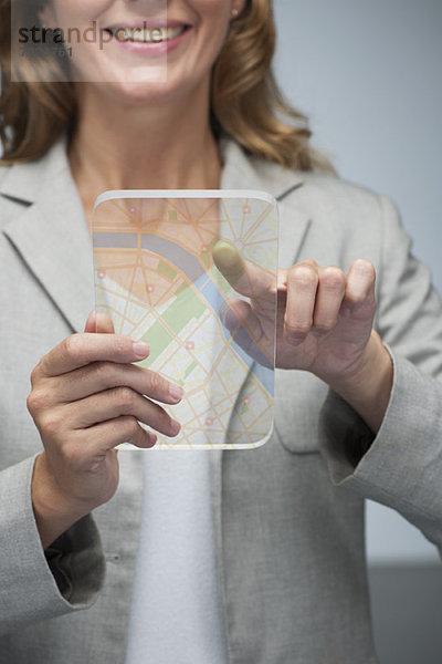 Frau mit Touchscreen-Technologie zur Darstellung der Karte auf transparentem Digital-Tablett
