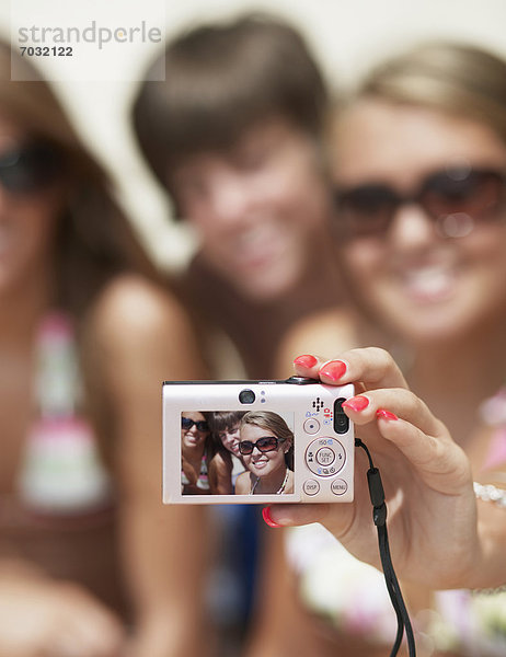 Teenagers Photographing Themselves  Focus on Camera