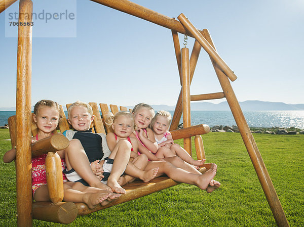 Portrait of children (2-3  4-5) on swing