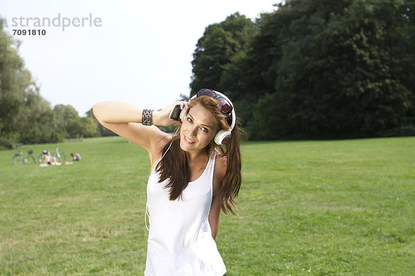 Young woman listening music at Treptower Park