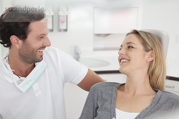 Germany  Dentist and patient in clinic  smiling