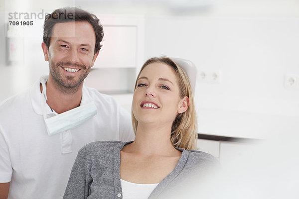 Germany  Dentist and patient in clinic  smiling