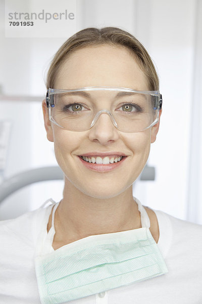 Germany  Dentist with safety glasses in dental office