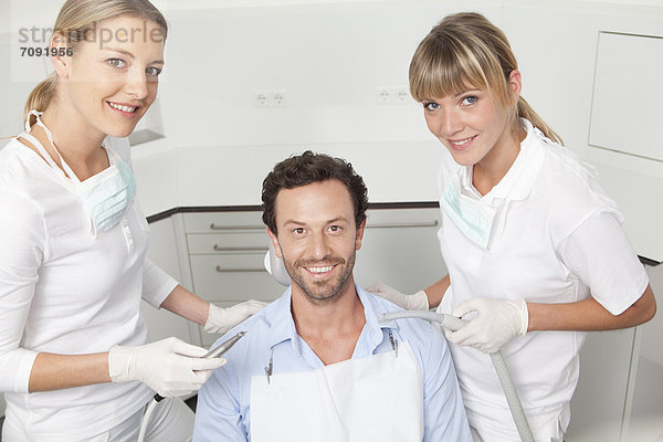 Germany  Mid adult man getting his teeth examined by dentist