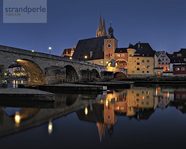 Germany  Bavaria  Regensburg  View of old stone bridge crossing Danube River at night