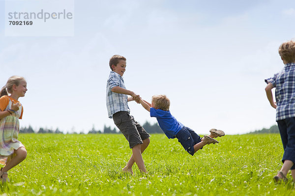 Germany  Bavaria  Group of children playing in meadow