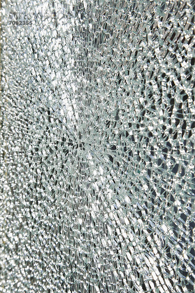 Broken glass window on telephone box  close up