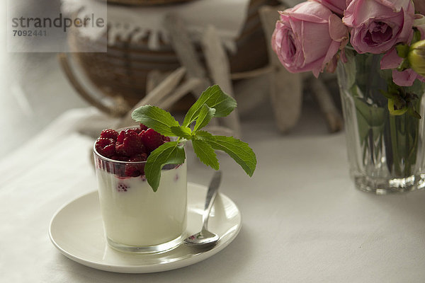 Glass of cream with raspberry and stevia  close up
