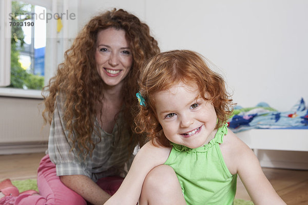 Germany  Berlin  Mother and daughter  smiling  portrait
