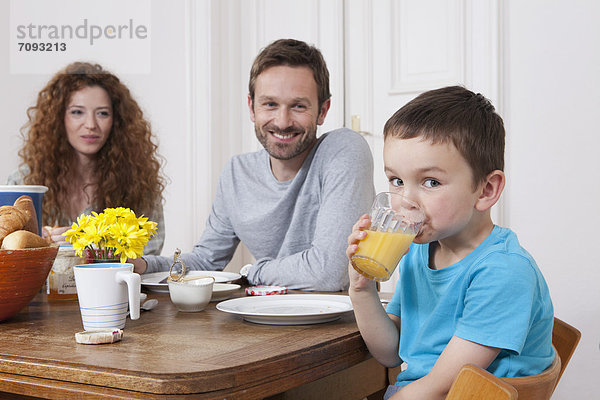 Germany  Berlin  Family having breakfast  smiling  portrait