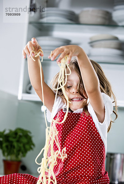 Germany  Girl playing with spaghetti