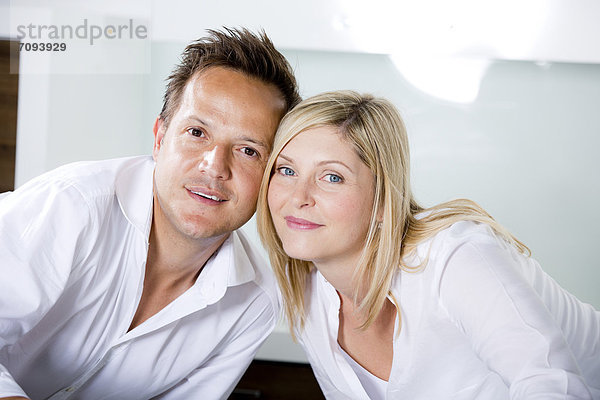 Germany  Mid adult couple standing in kitchen very close  portrait