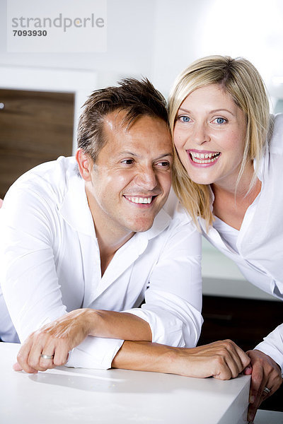 Germany  Mid adult couple in kitchen  smiling