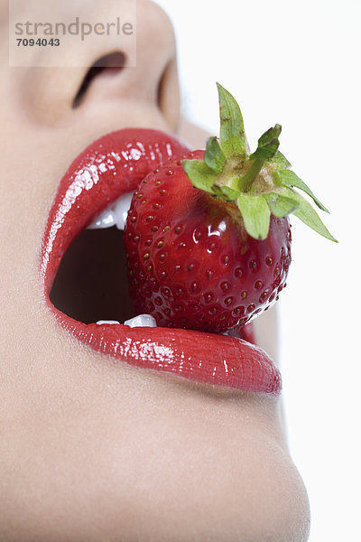 Young woman holding strawberry  close up