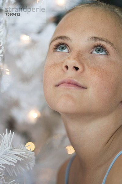 Preteen Mädchen neben Weihnachtsbeleuchtung