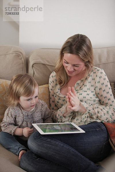 Mutter und Tochter beim Spielen mit dem digitalen Tablett