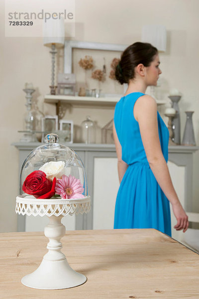 Frauen- und Kuchenstand mit Blumen in der Küche