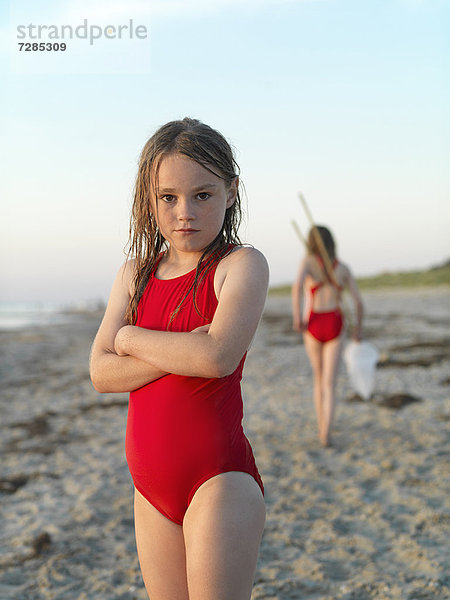 Mädchen am Sandstrand stehend