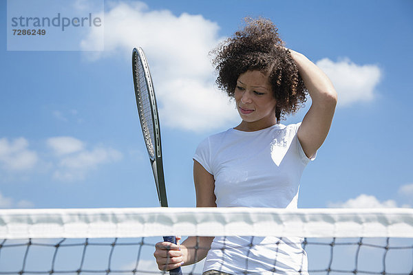 Tennisspieler mit Schläger auf dem Platz