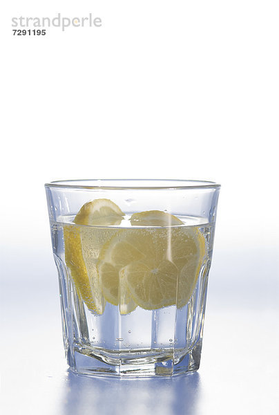 Glass of water with lemon slice on white background
